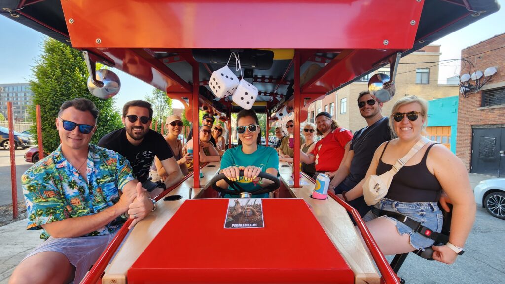 Trolley pub, smiling and wearing sunglasses on a sunny day.